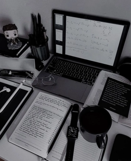 Workspace setup with laptop, notebooks, coffee mug, smartwatch, and digital devices used for planning content marketing strategy – Digital Marketing Specialist in Malappuram